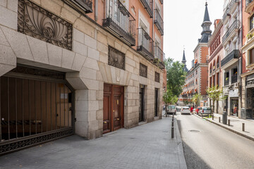 Central street in the city of Madrid with old buildings with large towers on the roofs
