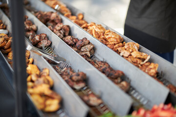 Grilled vegetables and chicken on distribution in iron trays , containers