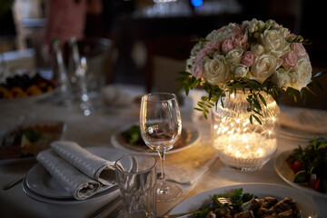 Served table. On the table are plates, dishes and glasses. 