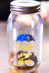 Rainy day fund savings jar with coins