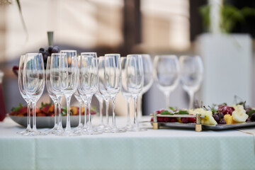 festive table setting, wine glasses and a plate of fruit on the table