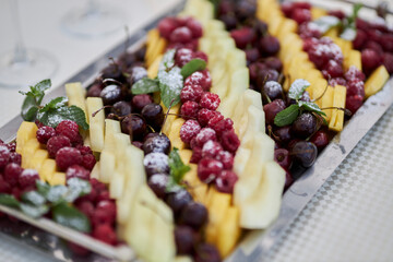 fruit platter on a metal tray, close-up, soft focus