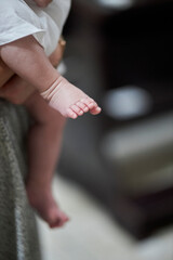 dad holds a small child in his arms, cropped image of children's legs