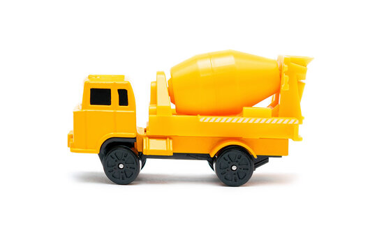 Colorful little mini yellow plastic concrete mixer, truck, lorry, car automobile toy isolated on white background mockup with copy space, toys for children, kids development, playing, childhood fun