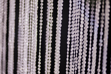 Wedding decorations. Decoration with threads of precious stones. soft focus. photo background of beads in the form of crystals 