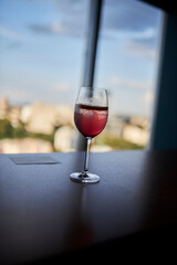 Glass with alcohol. A glass of wine on the table.