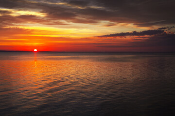 Dramatic sunset sky with clouds. Breathtaking sunset over the sea