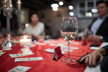 The company plays the mafia game. The glass is on the table