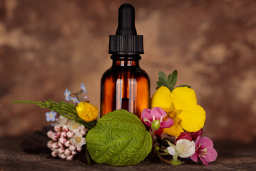 Mockup, bottle of essential oil with medicinal plants and flowers, phytotherapy, wellness and spa...
