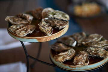 Oysters in two bowls. Oysters with lemon. Oysters in the restaurant on the table