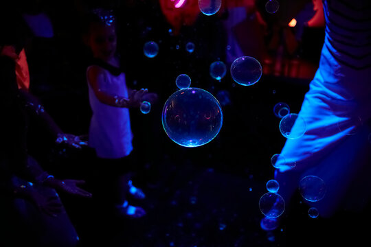 Soap bubbles in subdued blue lighting 
