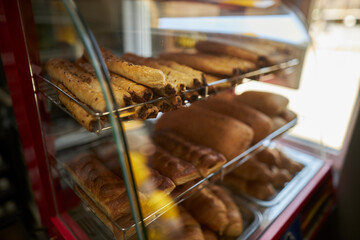 The buns are on the shelf in the bakery. Bakery