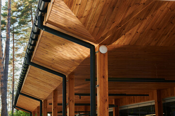 The veranda made of wood trim with plastic pipes for rain gutters