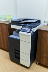 copier for printing stands in the interior of the office space