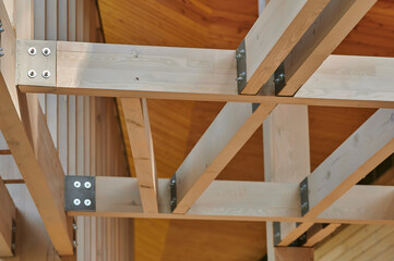 Obraz na płótnie Canvas building from construction beams with metal brackets