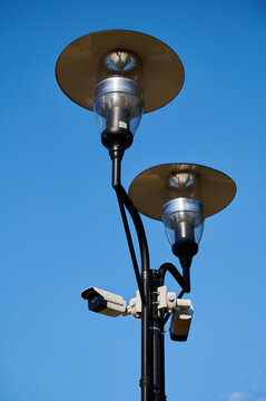 street lamppost with installed video surveillance cameras in the city