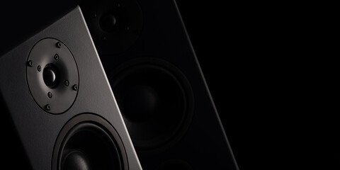 Stereo sound speakers closeup on black background with copy space. Contrast, accent lighting from...