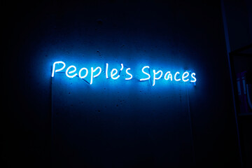  neon inscription in blue color. neon inscription people's space