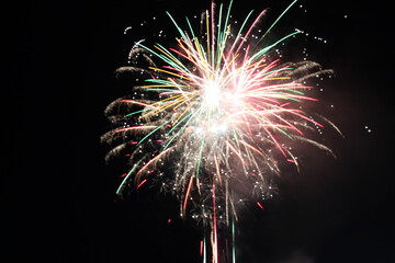 white red flashes rosette fireworks fireworks on a dark background holiday atmosphere celebrating...