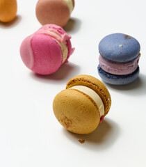 baked macarons with different flavors on a white background, top view