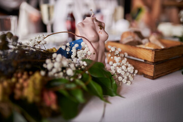 in a bright room at home. Candle in the form of naked female body. closeup shot