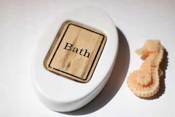 A bath object with bath texting and a candle 