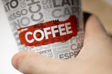 hand holding a coffee cup