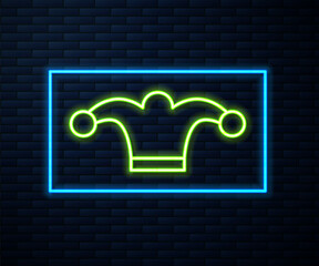 Glowing neon line Jester hat with bells isolated on brick wall background. Clown icon. Amusement park funnyman sign. Vector