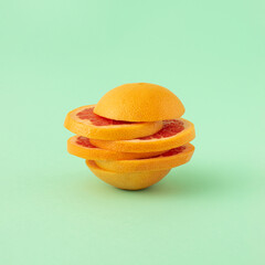 Creative idea made of grapefruit slices on pastel background. Summer organic tropical fruit concept.