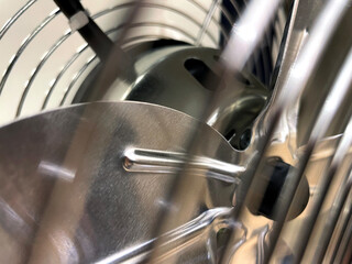 Close up of fan blades and the wireframe cage surrounding it