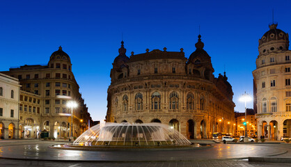 Fototapeta na wymiar Impressive architecture and fountain Piazza De Ferrari at dusk, Genoa, Italy.