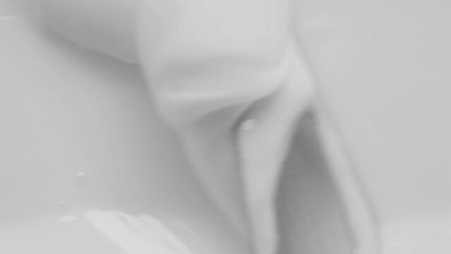 White skin care cream texture footage. White light creamy cosmetic beauty product smudge swipe closeup video. Moisturising creme swatch motion with spatula. Skincare cosmetics lotion mousse close up