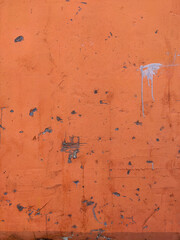 Orange Texture old wall with peeling paint, scratches and cracks