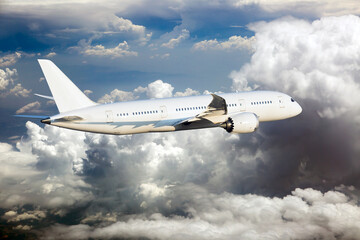 Fototapeta na wymiar White passenger plane in flight. The plane is flying over the clouds.