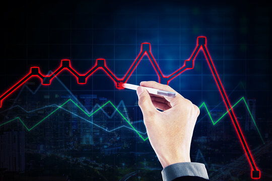 Businessman hand drawing declining chart