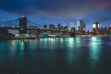 Fototapeta na wymiar Brooklyn Bridge at Night with Water Reflection in New York City
