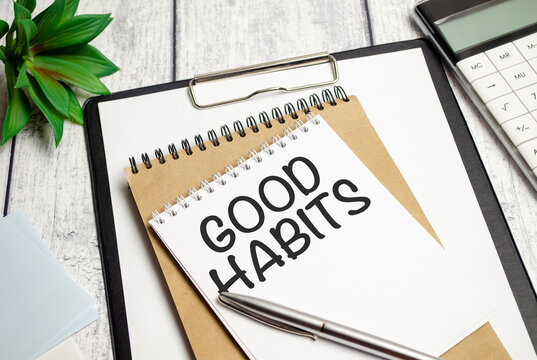 Good Habits text on notebook with pen on wooden background