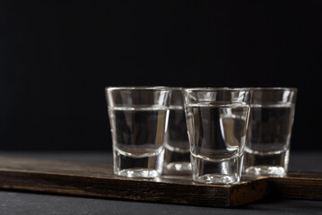 Vodka in a shot glass on black background