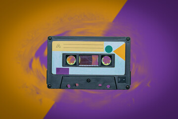 Retro tape recorder on a yellow-purple background.