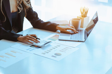 Asian female accountant or banker making calculations. Savings, finances and economy concept...