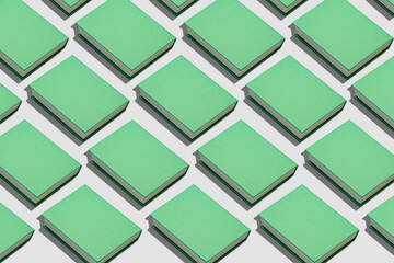 Many green books on light background. Pattern for design