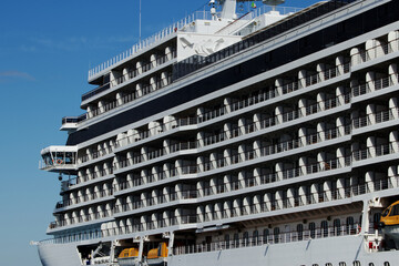 Close-up of large and white cruise ship on a clear blue sky