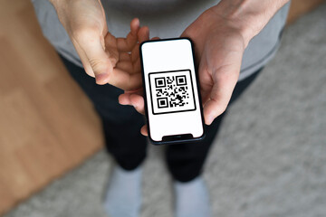 person hand hold smartphone with scanned qr code