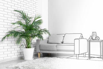 Interior of light living room with grey sofa, table and palm tree