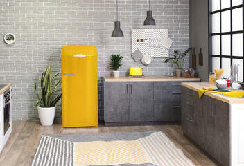 Interior of modern kitchen with yellow fridge