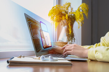 Woman using laptop with blocked screen at table. Concept of online safety