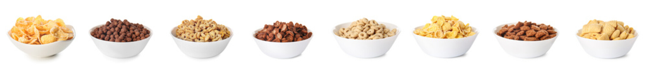 Bowls with different tasty breakfast cereals on white background