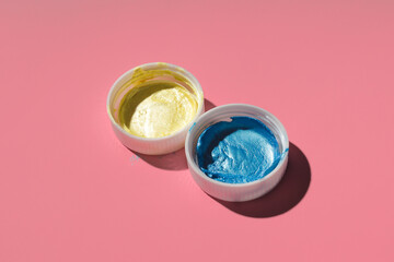 yellow and blue acrylic paint on a colored background