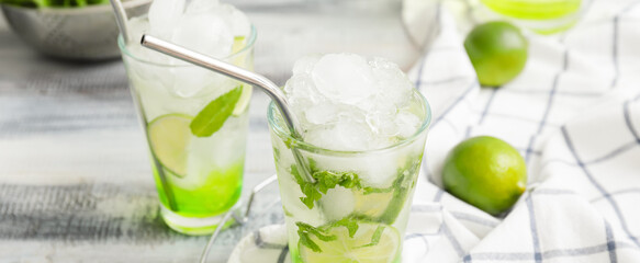 Glasses of fresh mojito on table, closeup