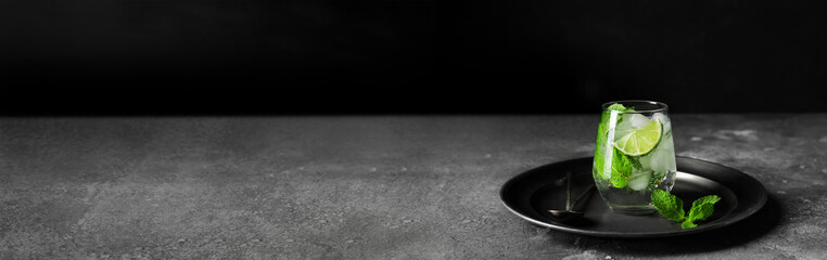 Glass of fresh mojito on grunge table. Banner for design